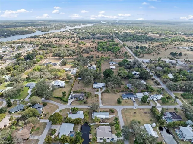 Aerial view of property's location with a large body of water and nearby suburban area