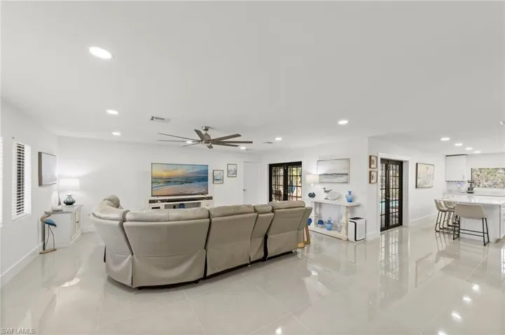 Living area featuring recessed lighting, a ceiling fan, and light tile patterned floors