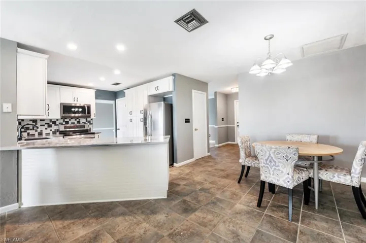 Lovely white cabinets in the kitchen with adjacent breakfast nook