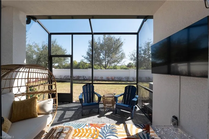 View of patio with a sunroom and glass enclosure