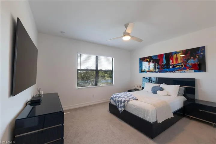 Bedroom with light carpet and ceiling fan