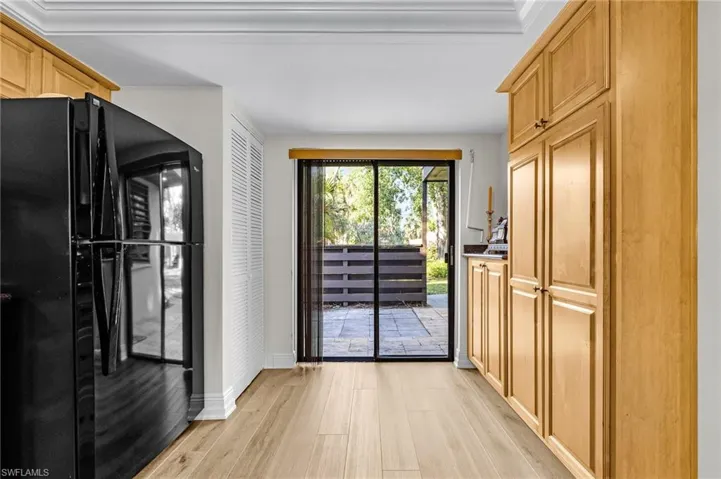 Doorway to outside featuring light wood-style floors and baseboards