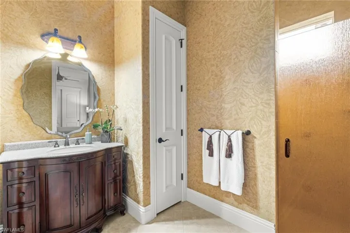 Bathroom with tile patterned floors and vanity