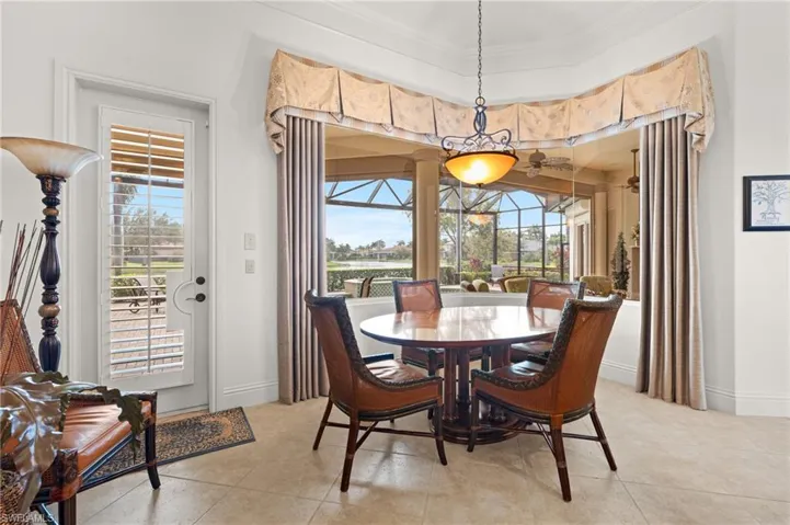 Tiled dining space featuring ornamental molding