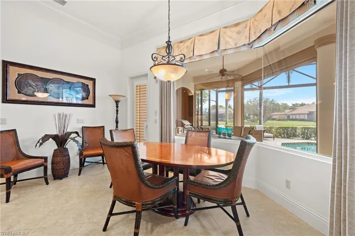 Dining room with ornamental molding and light tile patterned floors