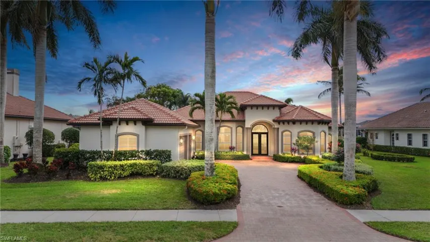 Mediterranean / spanish-style house featuring french doors and a yard