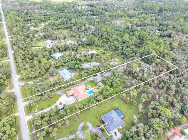 Aerial view of property and surrounding area with property boundaries highlighted