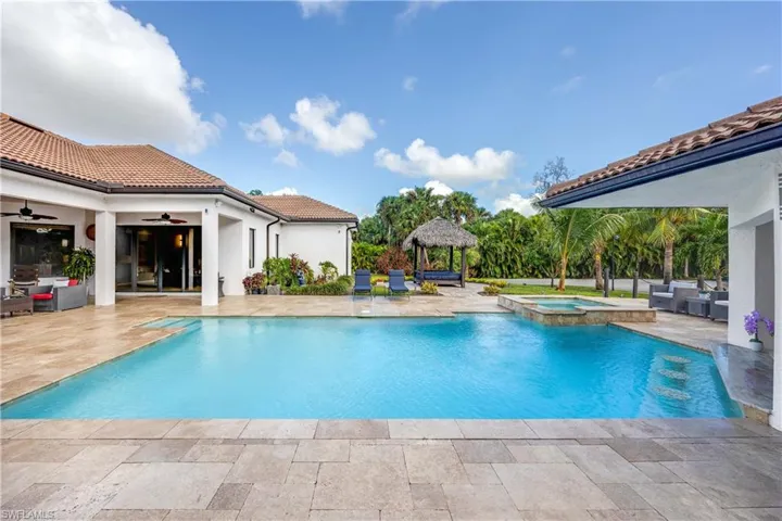 View of pool featuring a patio area and a pool with connected hot tub