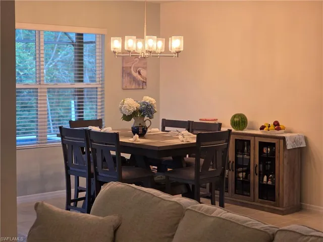 Dining area featuring a chandelier and tile patterned flooring