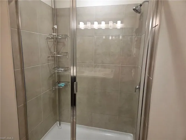 Full bath featuring a shower stall