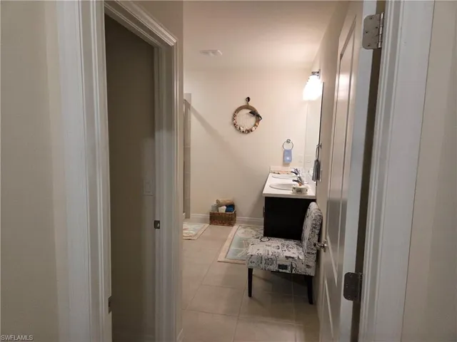 Bathroom with tile patterned floors and vanity
