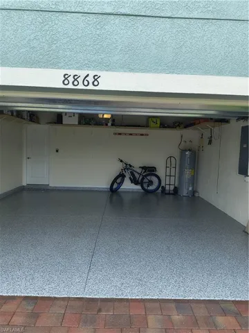 Garage with water heater and electric panel