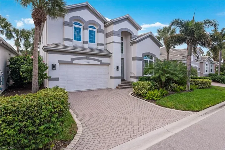 Mediterranean / spanish-style home with stucco siding, decorative driveway, and a garage