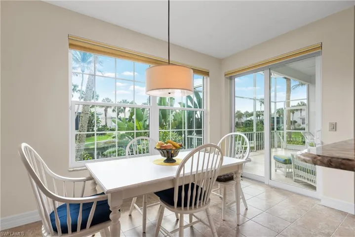 Dining space featuring light tile patterned flooring and baseboards