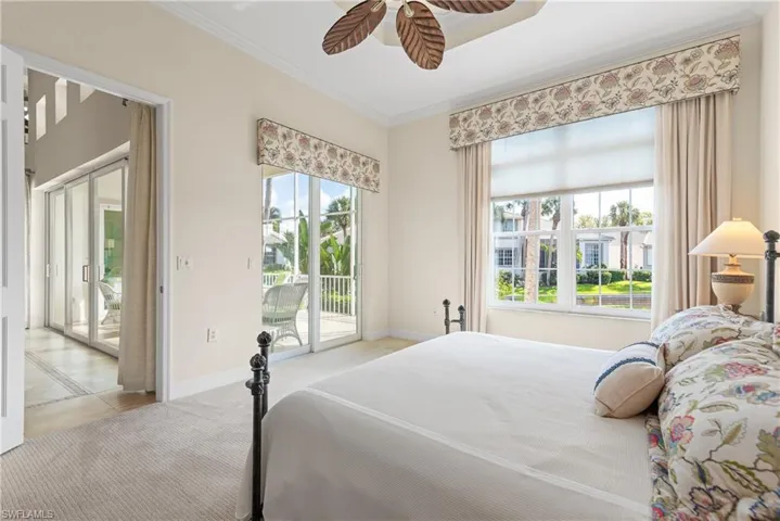 Carpeted bedroom featuring ornamental molding, access to outside, and a ceiling fan