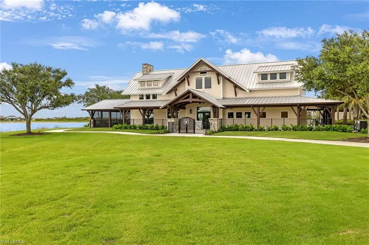 View of front of property featuring a water view and a front lawn