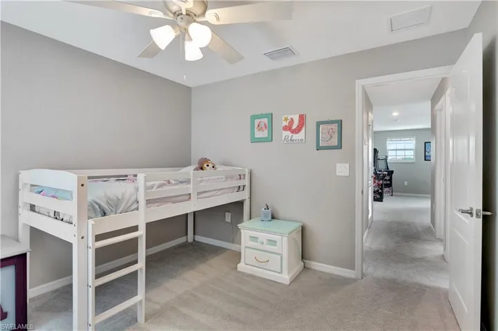 Bedroom with light colored carpet and ceiling fan