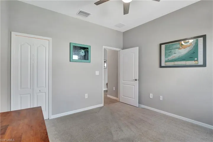 Unfurnished bedroom featuring carpet flooring, a closet, and ceiling fan