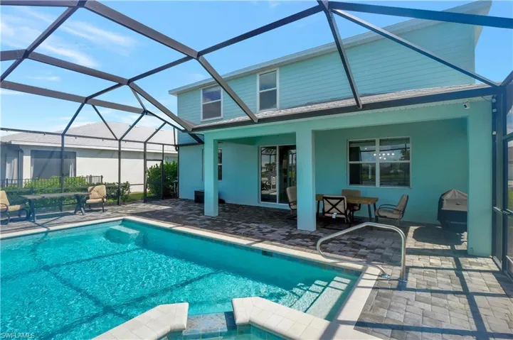 View of swimming pool with a patio and a lanai