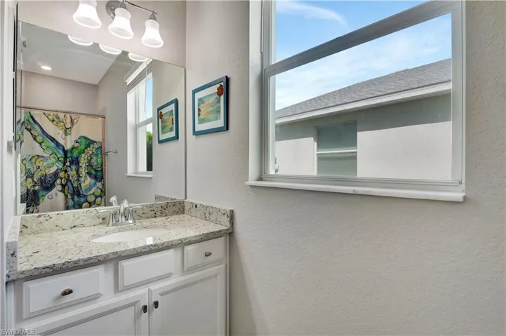 Bathroom featuring vanity and an inviting chandelier