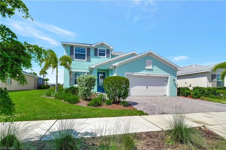 View of front of home featuring a garage and a front lawn