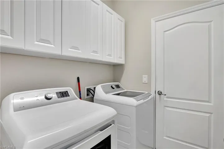 Laundry area with cabinets and independent washer and dryer