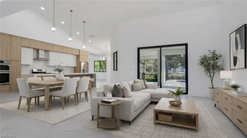 Virtually Staged Living area with recessed lighting and vaulted ceiling