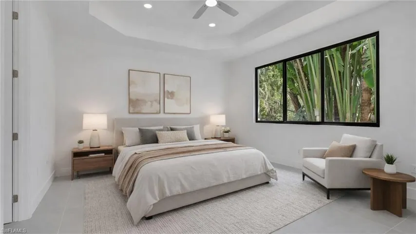 Virtually Staged Bedroom with a tray ceiling, a ceiling fan, and recessed lighting