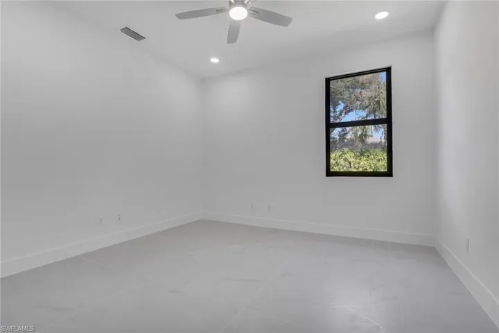 Empty room featuring recessed lighting and a ceiling fan