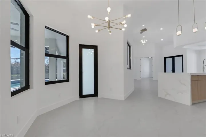 Spare room featuring a ceiling fan, a tray ceiling, and recessed lighting