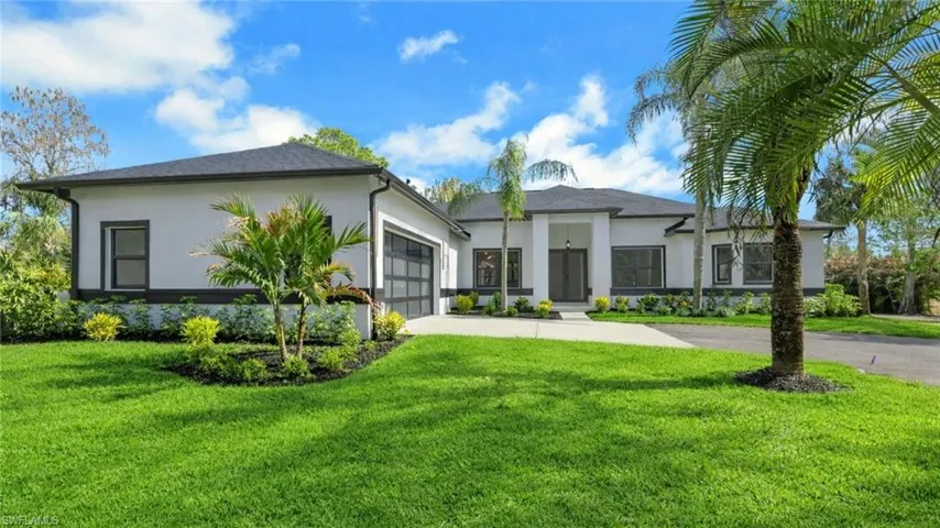 Virtually Staged View of front of house with stucco siding, a front lawn, driveway, and an attached garage