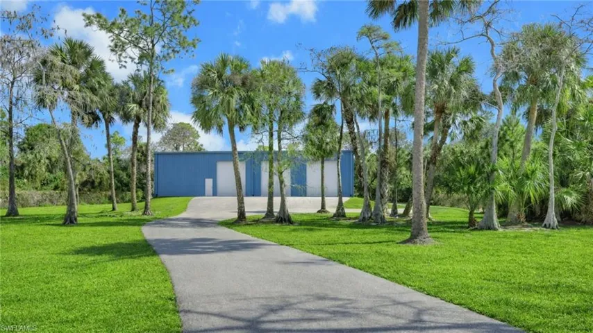 Virtually Staged Surrounding community with an outbuilding and driveway