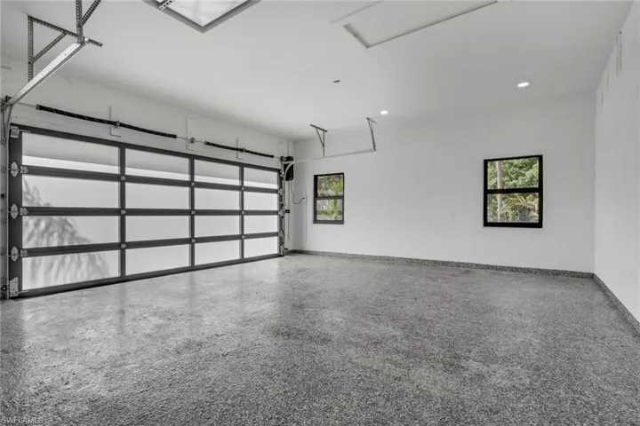 Garage with baseboards and recessed lighting