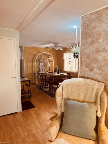 Living room with ceiling fan and light wood-style floors