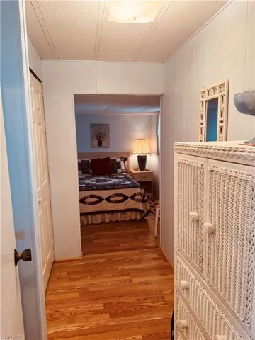 Bedroom with light wood-type flooring and a textured ceiling