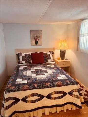 Bedroom featuring wood finished floors and a textured ceiling