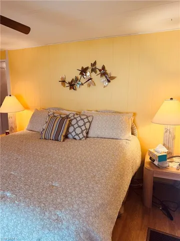 Bedroom featuring ceiling fan and wood finished floors