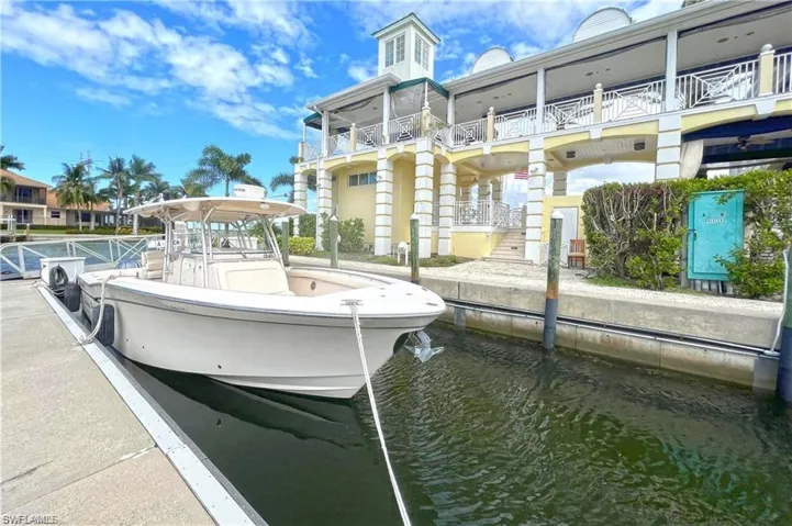 Dock area featuring a balcony and a water view