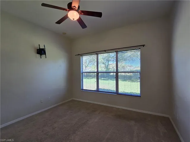 Unfurnished room with carpet and ceiling fan