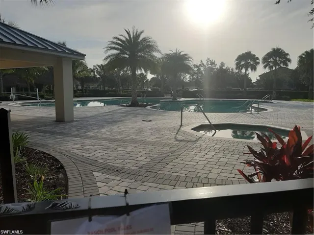Community pool with a patio and a community hot tub