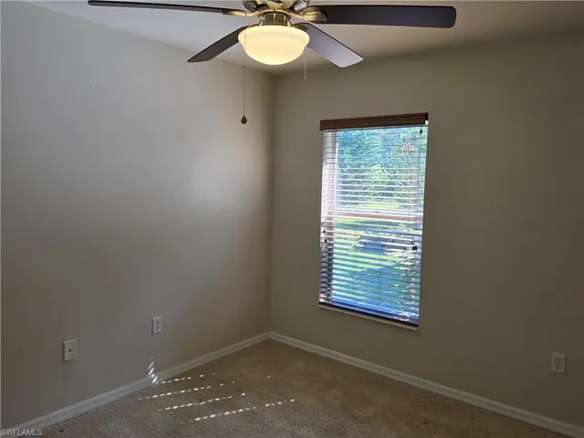 Carpeted bedroom room featuring baseboards and ceiling fan