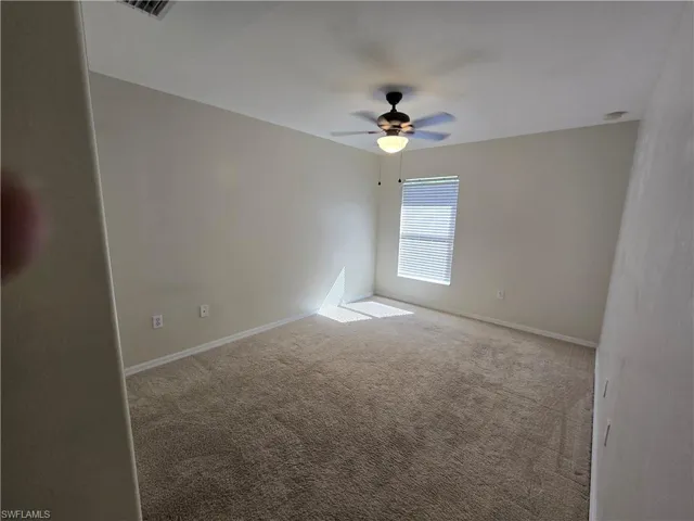 Room featuring carpet floors and ceiling fan