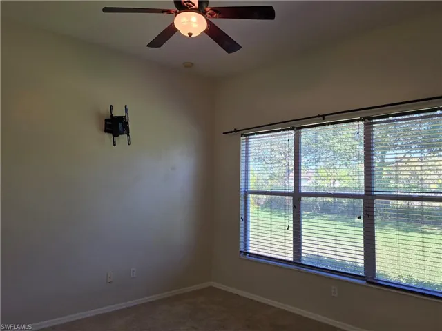 Master bedroom featuring carpet and ceiling fan