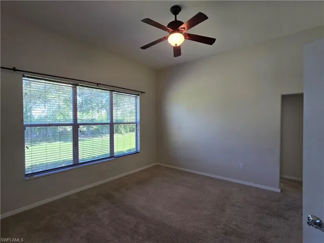 Master bedroom with carpet and ceiling fan and lots of natural light.