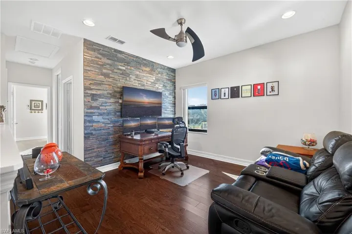 Office with dark wood-style flooring, ceiling fan, and recessed lighting