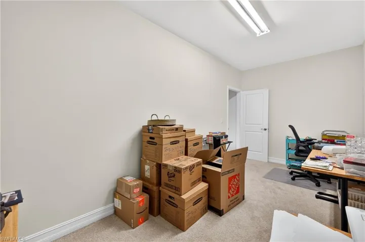 Office space featuring light carpet and baseboards