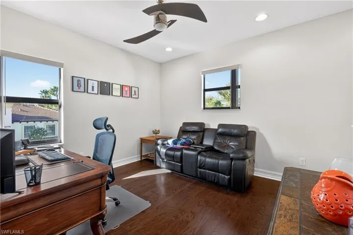 Office with dark wood-type flooring, ceiling fan, and recessed lighting