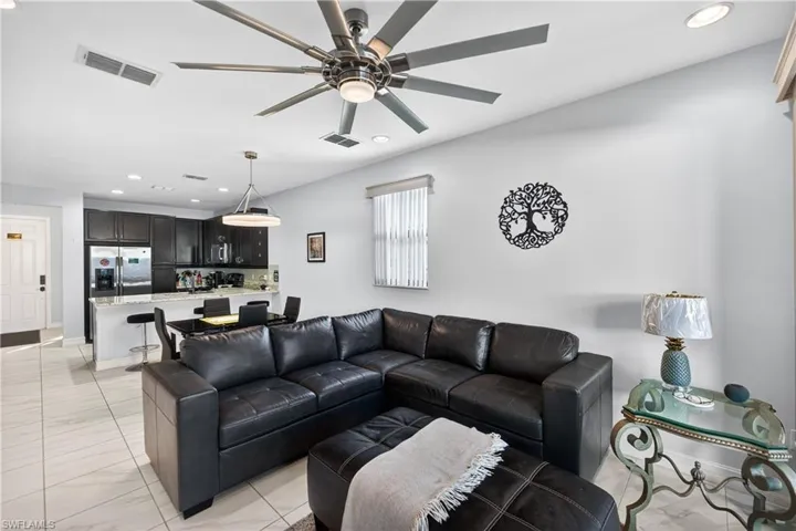 Living area featuring recessed lighting and a ceiling fan