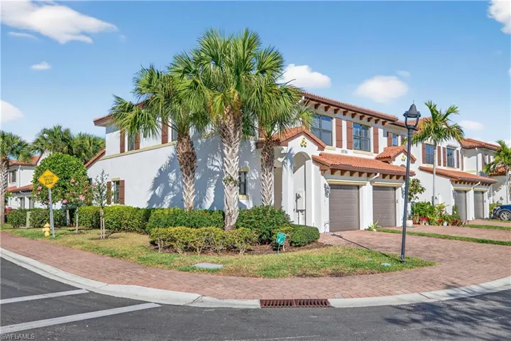 Mediterranean / spanish-style home with an attached garage, stucco siding, decorative driveway, and a tile roof