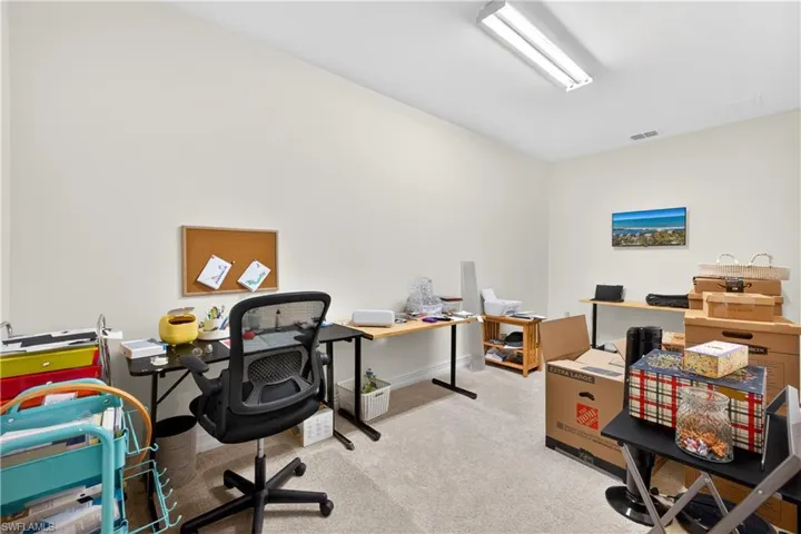 Office with light carpet and baseboards